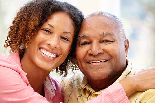 African american father and daughter smiling with heads touching